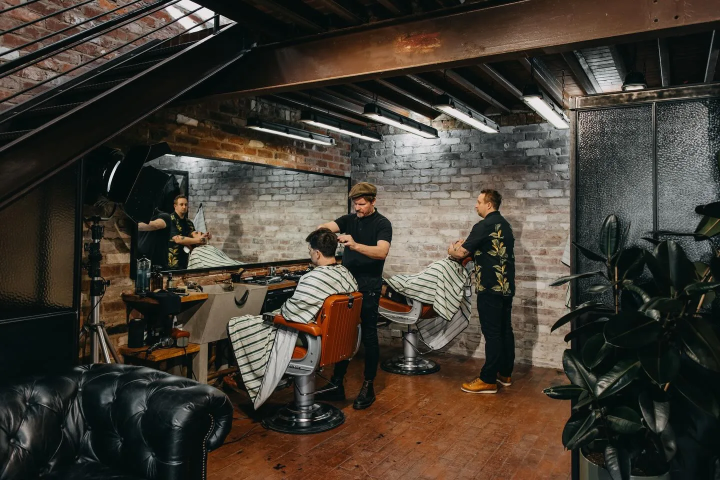 Barbers working the chairs on the shop floor at The Two Georges, Fremantle