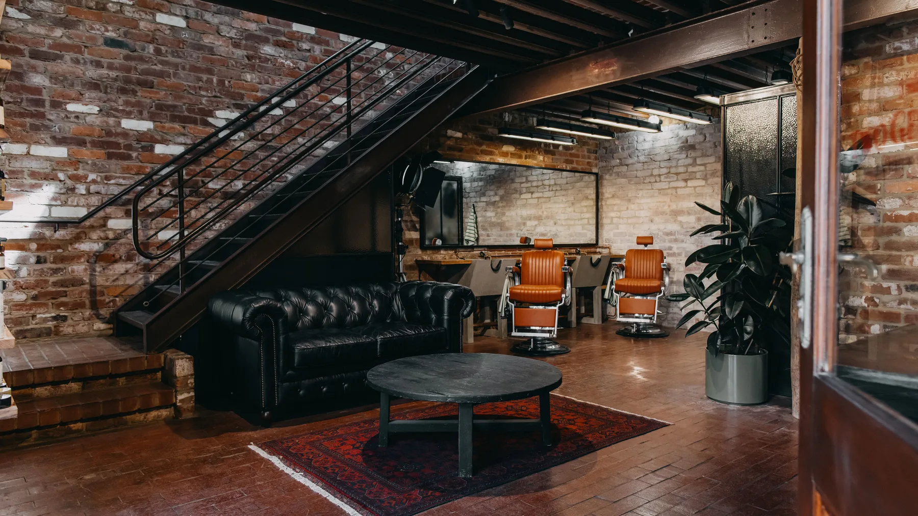 The lounge, Chesterfield and barber chairs inside The Two Georges