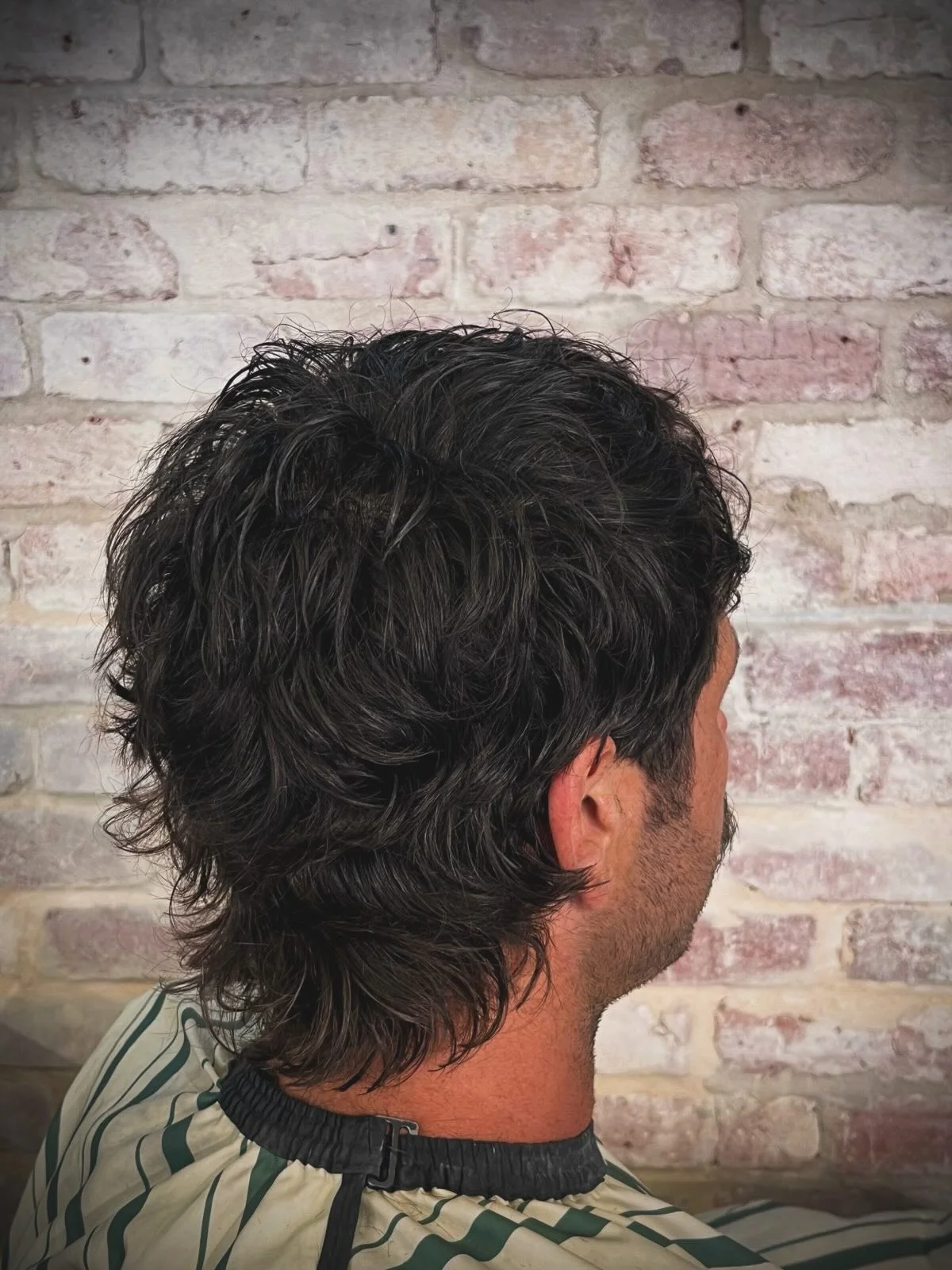 The back of a curly mullet cut at The Two Georges, Fremantle