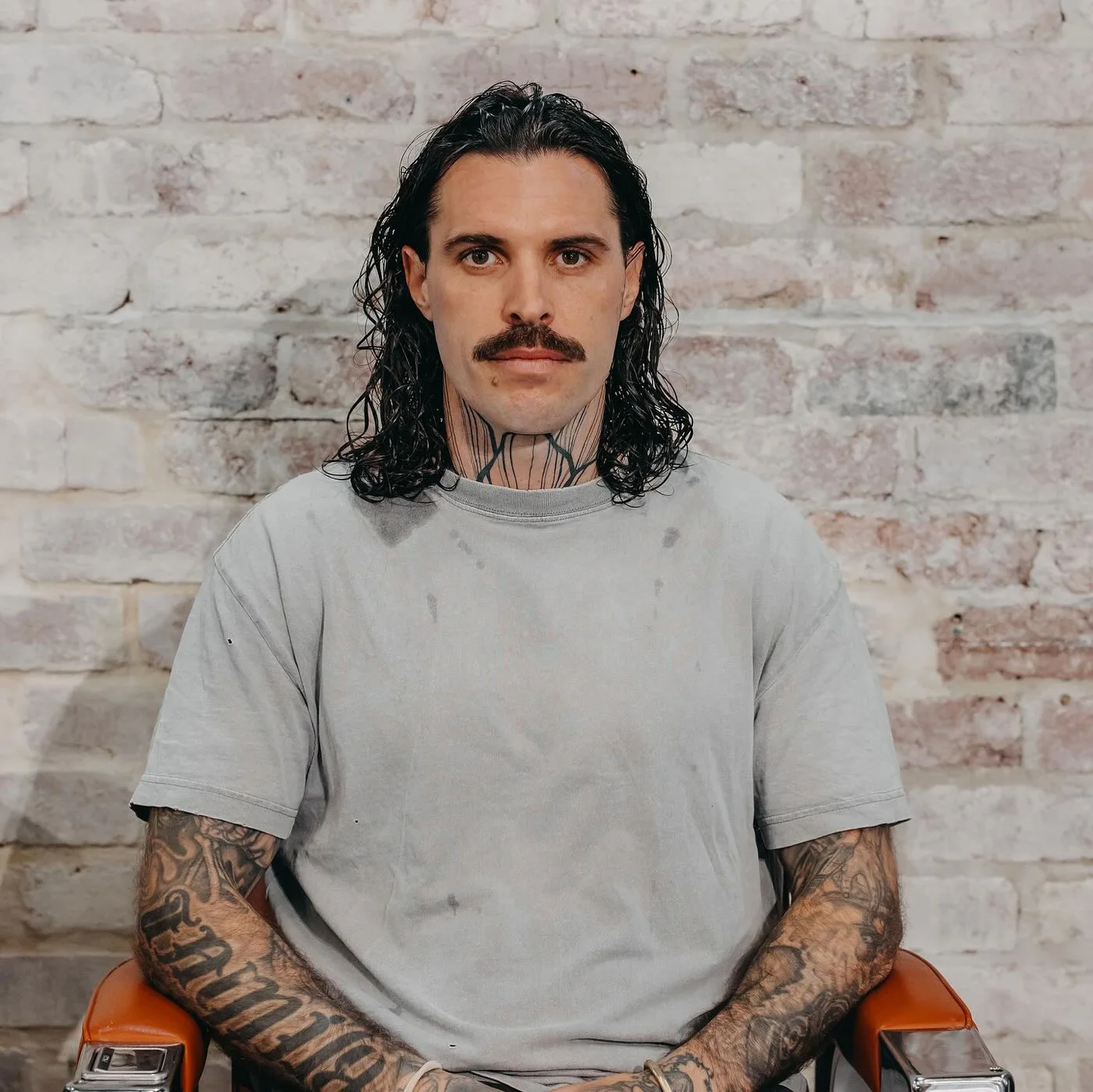A finished mullet, front on, against the shop&rsquo;s brick wall